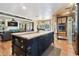 Gourmet kitchen island with butcher block countertop, black cabinetry, and views of the living spaces at 3018 Pemberton Trace Ct, Plant City, FL 33565