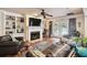 Inviting living room with a fireplace, built-in shelving, and glass doors to the outdoor pool area at 3018 Pemberton Trace Ct, Plant City, FL 33565