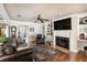 Comfortable living room featuring a fireplace, hardwood floors, built-in shelving, and a cozy seating area at 3018 Pemberton Trace Ct, Plant City, FL 33565