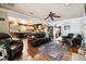 Open-concept living room with hardwood floors, leading into a spacious kitchen and offering ample seating at 3018 Pemberton Trace Ct, Plant City, FL 33565