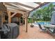 Outdoor patio featuring a grill, furniture, and a pergola leading to a pool at 3018 Pemberton Trace Ct, Plant City, FL 33565