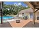 Relaxing backyard with pool, patio, lounge chairs, fire pit and outdoor dining set at 3018 Pemberton Trace Ct, Plant City, FL 33565
