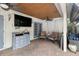 Charming outdoor porch with a television, ceiling fan, and cozy seating area at 3018 Pemberton Trace Ct, Plant City, FL 33565