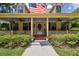 Inviting front porch with ceiling fans, hanging plants, and comfortable seating, perfect for relaxing outdoors at 3018 Pemberton Trace Ct, Plant City, FL 33565