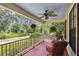 Inviting front porch with comfortable seating, offering a relaxing outdoor space with decorative pillows and green foliage at 3018 Pemberton Trace Ct, Plant City, FL 33565