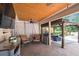 Spacious covered porch featuring cozy seating, brick floors, and ceiling fans at 3018 Pemberton Trace Ct, Plant City, FL 33565
