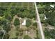 Aerial view of property with large ponds, treed acreage, road frontage, and a residential structure at 3203 21St Se Ave, Ruskin, FL 33570