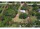 Aerial view of the property showing the house, outbuildings, landscaping, and perimeter at 3203 21St Se Ave, Ruskin, FL 33570