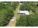 Aerial view of the property showcasing the house, surrounding trees, and ample outdoor space at 3203 21St Se Ave, Ruskin, FL 33570