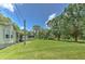 Spacious backyard with lush lawn, mature trees, and potential for outdoor activities at 3203 21St Se Ave, Ruskin, FL 33570