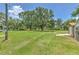 Expansive backyard featuring mature trees and a shed, offering ample space for outdoor activities at 3203 21St Se Ave, Ruskin, FL 33570
