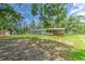 Backyard view featuring a spacious yard, shed, and screened-in porch at 3203 21St Se Ave, Ruskin, FL 33570