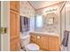 Cozy bathroom with floral wallpaper, a single sink vanity, and a walk-in shower at 3203 21St Se Ave, Ruskin, FL 33570