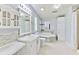 Relaxing bathroom featuring a tub, tiled backsplash, vanity, and ample storage at 3203 21St Se Ave, Ruskin, FL 33570