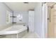 Bathroom featuring a tub with tiled backsplash and a convenient shower area at 3203 21St Se Ave, Ruskin, FL 33570