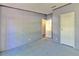 Comfortable bedroom with gray walls and an open closet with hanging clothes at 3203 21St Se Ave, Ruskin, FL 33570