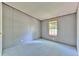 Cozy bedroom with light blue carpet, a small window and light grey walls at 3203 21St Se Ave, Ruskin, FL 33570