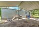 Exterior view of the home with an attached carport and stairs leading to the back door at 3203 21St Se Ave, Ruskin, FL 33570