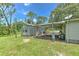 Home exterior featuring carport, well-maintained lawn, and peaceful surroundings at 3203 21St Se Ave, Ruskin, FL 33570