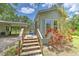 Front exterior of home featuring a wooden deck with stairs and landscaped yard at 3203 21St Se Ave, Ruskin, FL 33570