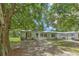 Charming single-story home with a covered front porch, well-maintained landscaping, and mature trees at 3203 21St Se Ave, Ruskin, FL 33570