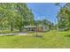 Charming home exterior with well-maintained lawn, mature trees, and basketball hoop at 3203 21St Se Ave, Ruskin, FL 33570