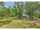 Charming home with a spacious front yard, mature trees, and a well-maintained lawn at 3203 21St Se Ave, Ruskin, FL 33570