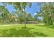 Well-manicured front yard with mature trees providing shade, offering a serene and inviting atmosphere at 3203 21St Se Ave, Ruskin, FL 33570