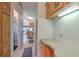 Hallway leading to kitchen and living area, with wooden cabinets and ample storage at 3203 21St Se Ave, Ruskin, FL 33570