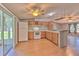 Functional kitchen with white appliances, breakfast bar, wood cabinets, and ceiling fan at 3203 21St Se Ave, Ruskin, FL 33570