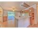 Functional kitchen with white appliances, breakfast bar, wood cabinets, and ceiling fan at 3203 21St Se Ave, Ruskin, FL 33570