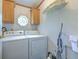 Functional laundry room with washer, dryer, and shelving for storage and organization at 3203 21St Se Ave, Ruskin, FL 33570