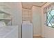 Laundry room with washer and dryer, storage shelves, and exterior access at 3203 21St Se Ave, Ruskin, FL 33570
