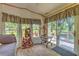 Cozy living room featuring wood-look floors, large windows, and artistic decor at 3203 21St Se Ave, Ruskin, FL 33570