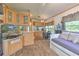 Open living space featuring wood-look flooring and a day bed with a TV at 3203 21St Se Ave, Ruskin, FL 33570