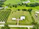 Wide aerial shot of property, highlighting expansive lawn, long driveway, and serene rural surroundings at 3212 E Merrin Rd, Plant City, FL 33567