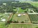 Desirable property showcasing a charming home, pool, storage building surrounded by expansive landscapes and lush greenery at 3212 E Merrin Rd, Plant City, FL 33567