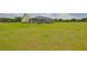 Large backyard showcasing the home's screened-in porch and a sprawling lawn area at 3212 E Merrin Rd, Plant City, FL 33567