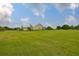 Expansive backyard showcasing the property's generous lawn area and the home's screened-in outdoor area at 3212 E Merrin Rd, Plant City, FL 33567