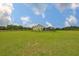 Spacious backyard highlighting the home's generous lawn area and screened-in outdoor living space at 3212 E Merrin Rd, Plant City, FL 33567