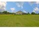 Expansive green backyard showcases the property's large lawn and the home's screened-in porch at 3212 E Merrin Rd, Plant City, FL 33567