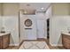 Elegant bathroom entrance with double vanity sinks, decorative tile flooring, and a walk-in shower at 3212 E Merrin Rd, Plant City, FL 33567