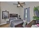 Stylish bedroom features a ceiling fan, unique guitar decor, and modern furnishings at 3212 E Merrin Rd, Plant City, FL 33567