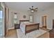 Comfortable bedroom features a ceiling fan, plush carpet, and lots of natural light through windows at 3212 E Merrin Rd, Plant City, FL 33567