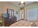 Comfortable bedroom features a large dresser, TV, and ceiling fan at 3212 E Merrin Rd, Plant City, FL 33567
