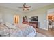 Relaxing bedroom features a ceiling fan, dresser, and television at 3212 E Merrin Rd, Plant City, FL 33567