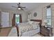 Bright bedroom with a ceiling fan, neutral decor, and sliding glass doors leading to the backyard at 3212 E Merrin Rd, Plant City, FL 33567