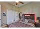 Cozy bedroom with a ceiling fan, modern decor, and ample closet space at 3212 E Merrin Rd, Plant City, FL 33567