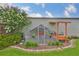 Charming chicken coop in a well-maintained yard with flowering bushes at 3212 E Merrin Rd, Plant City, FL 33567