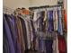 Neatly organized walk-in closet with hanging clothes and shelving at 3212 E Merrin Rd, Plant City, FL 33567